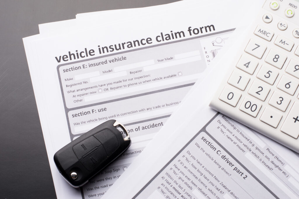 Vehicle Insurance Claim Form next to car keys