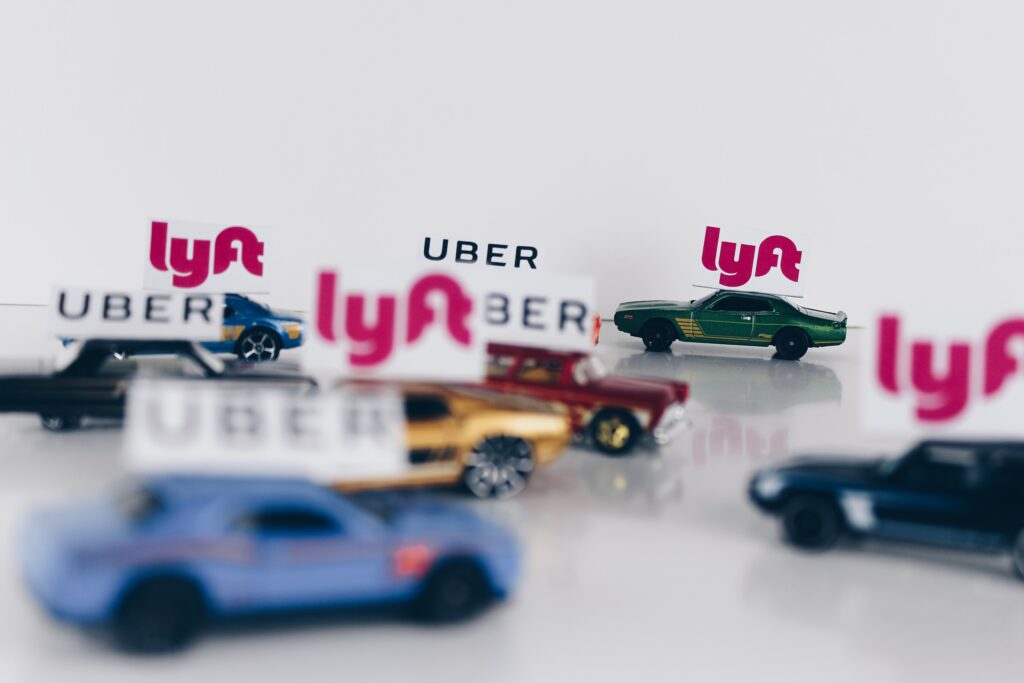 toy cars with Uber and Lyft signs posted to the roofs