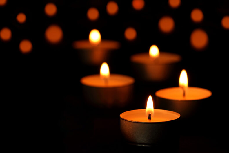 funeral candle flames glowing in the dark.