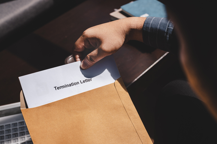 Termination of Employment and layoff concept, received Termination of Employment Form in paper brown envelope.